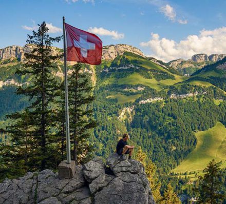Tourist sitting on the Ebenalp mountain in the Swiss Alps of Switzerland