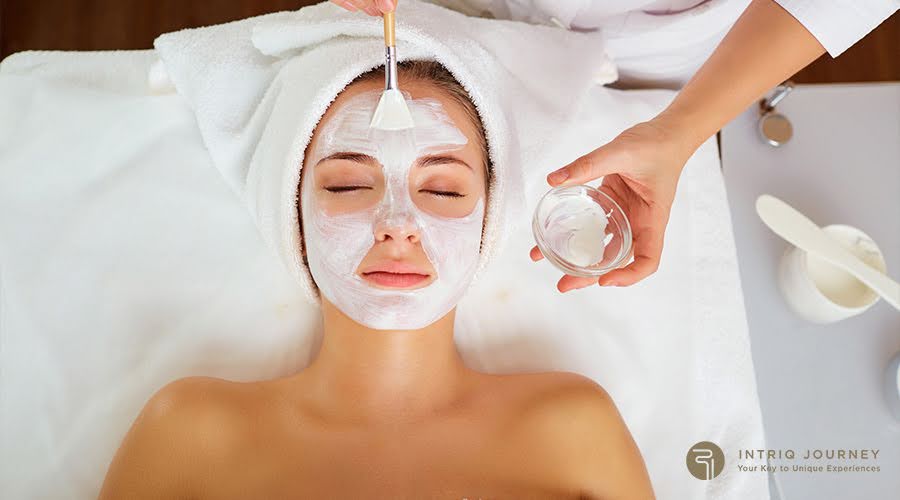 woman relaxing while receiving a rejuvenating facial treatment