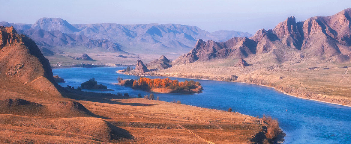 Blue river flowing through arid mountain landscape in Southern Xinjiang.