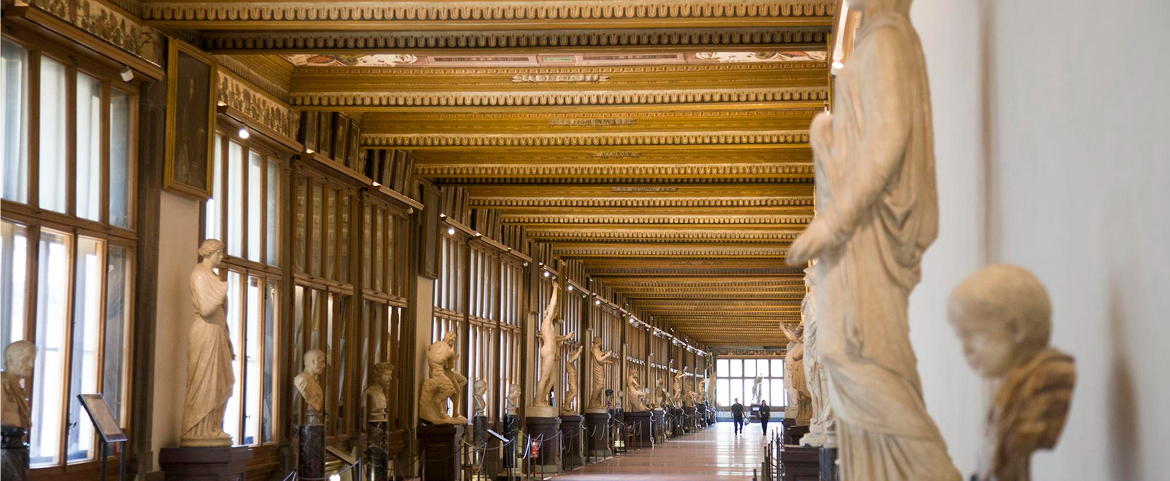 Classical sculptures lining the Uffizi Gallery corridor in Florence.