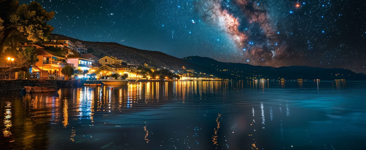 Milky Way over a peaceful lakeside village at night.